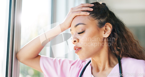 Image of Nurse, thinking or stress headache by window in hospital, clinic or wellness theater and mental health burnout or anxiety. Exhausted, fatigue or tired healthcare woman in surgery mistake or work risk