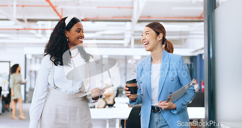 Image of Office communication, walking and diversity women talking about funny company news, partnership or collaboration. Coffee friends conversation, tablet and black woman and Asian girl in chat discussion