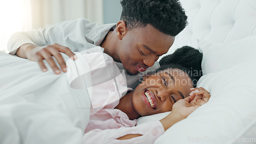 Image of Relax, couple and love in bedroom kiss, rest and comfort in happy relationship together at home. Man and woman lying in bed relaxing, talk and smile in comfortable house and morning happiness