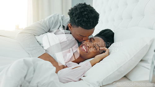 Image of Relax, couple and love in bedroom kiss, rest and comfort in happy relationship together at home. Man and woman lying in bed relaxing, talk and smile in comfortable house and morning happiness