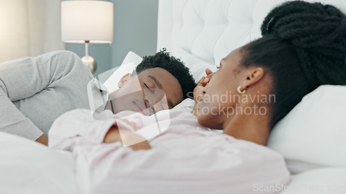 Image of Divorce, angry and bed with a sad woman with insomnia shaking her head at her sleeping husband in the bedroom of their home. Erectile dysfunction, cheating or jealous with an upset female and her man