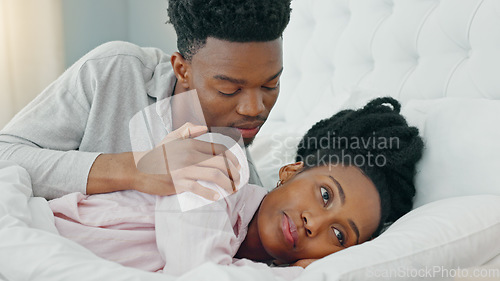 Image of Relationship problems, upset and unhappy woman ignoring man after arguing, cheating or pms while lying in bed. Black couple feeling sad or depressed about marriage or relationship issues or trouble