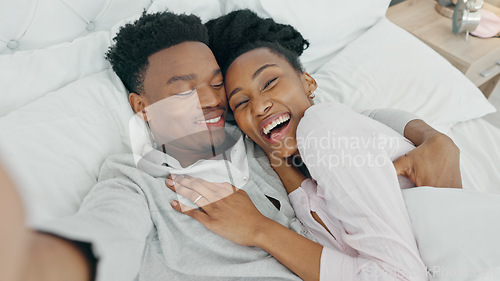 Image of Selfie influencer couple in bed and portrait smile for fun indoor weekend or waking up together in the morning. Fun, happy black people in bedroom and a POV portrait photo for social media content