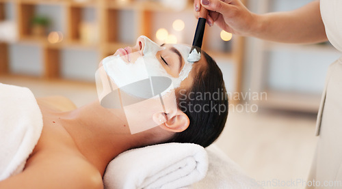 Image of Skincare, beauty and spa facial with woman face mask at a wellness, health and salon. Relax, luxury and and girl resting while beautician hands apply exfoliation, peeling and hydration skin product