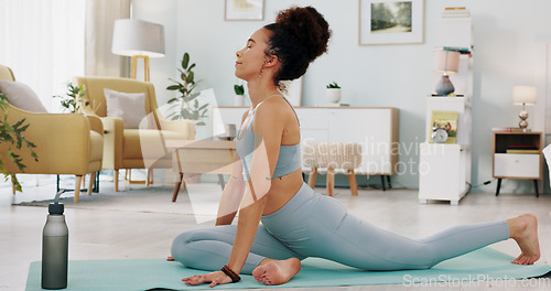 Image of Fitness, yoga or meditation stretching woman for workout in the living room of her house. Girl with chakra focus, mindset or balance while training, exercise or health with zen pilates for wellness.