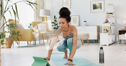 Image of Exercise, yoga and tablet with fitness woman streaming online class, tutorial or live stream on internet virtual training in lounge at home. Fit female using technology for spiritual wellness workout