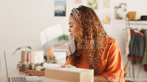 Image of Clipboard, laptop and black woman writing in clothing store working on sales or delivery. Fashion, manager and worker in South Africa in small business, fashion shop and planning schedule on computer