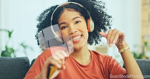 Image of Black woman, dancing and headphones on sofa, being content and singing words in living room. Young girl, headset and digital device for contemporary dancer, moving with rhythm and relax on break.