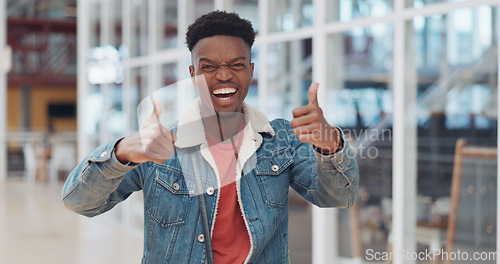 Image of Thumbs up, black man and celebrate success in trendy startup, marketing agency and motivation for winning, goals and agreement. Happy worker, hipster and guy thumb up in support, trust and hand emoji