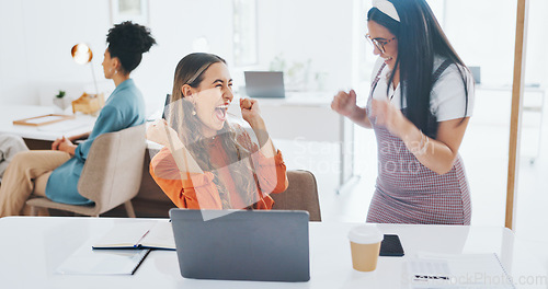 Image of Success, fist bump or happy employees with a handshake in celebration of digital marketing sales goals at office desk. Laptop, winner or excited women celebrate winning an online business deal at job