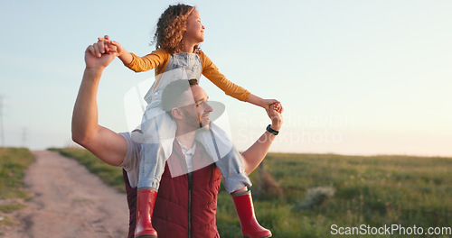 Image of Happy, father and child on shoulders in the countryside enjoying quality bonding time together in nature. Dad giving his little girl a piggyback with smile, love and care for the natural environment