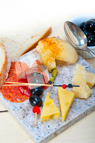 Image of mix cold cut on a stone with fresh pears