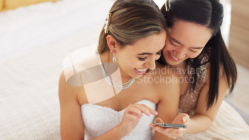 Image of Friends, bride and bridesmaid smartphone selfie smile together for fun wedding photograph memory. Happy, joyful and cute women friendship with asian and caucasian woman looking at bridal pictures.