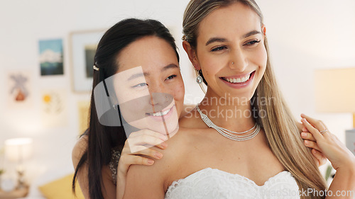 Image of Wedding, bride and bridesmaid looking happy, proud and excited share hug, joy and love wearing white dress and ready for ceremony. Interacial asian woman and friend laughing waiting for a celebration