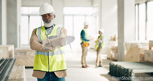 Image of Construction, leadership and engineer with a black man architect standing on a building site with his arms crossed. Architecture, design and manager with a mature male supervisor and his team