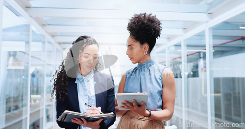 Image of Mentor, discussion and business women walking in office workplace. Leadership, coaching and group of people or employees in hallway talking, planning or brainstorming project with tablet and books.