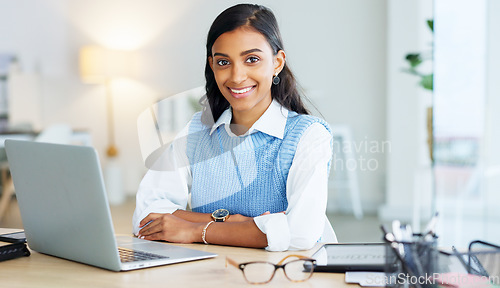 Image of Portrait of a young entrepreneur networking with clients online using her laptop. One happy female corporate intern browsing the internet and typing and sending emails for her manager