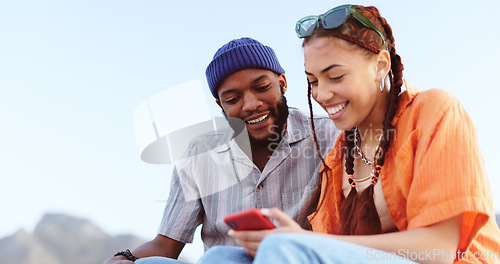 Image of Couple, diversity love and phone in nature, outdoors or outside on holiday, vacation or trip. Happy, smile and man, woman and 5g mobile app, social media or web surfing online on tech while talking.