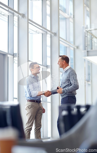 Image of Business people, handshake or greeting in hotel lobby, modern office or airport lounge in CRM meeting. Smile, happy or mature workers shaking hands in partnership deal, collaboration or b2b agreement