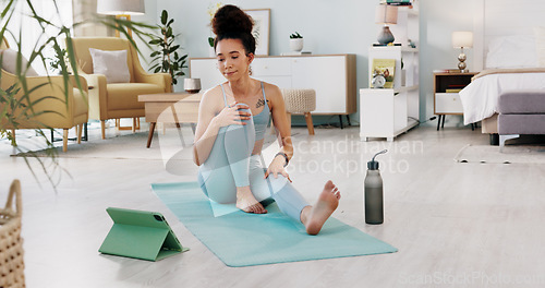 Image of Exercise, yoga and tablet with fitness woman streaming online class, tutorial or live stream on internet virtual training in lounge at home. Fit female using technology for spiritual wellness workout