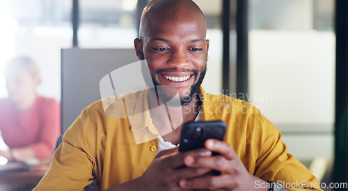 Image of Black man, phone and office chat while online for communication, social media or reading email, news or content creator post. Smile on face of employee at desk for project research on website