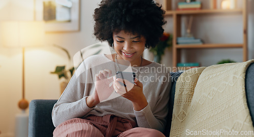 Image of Social media phone, happy email and black woman with smile for mobile app notification, reading news on the internet and chat on the web. African girl in communication on smartphone on lounge sofa