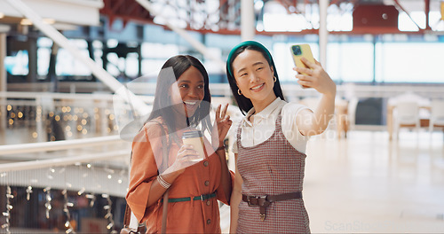 Image of Phone selfie, women and friends with peace sign at mall taking pictures for social media. Bokeh, hand gesture and girls taking photo on mobile smartphone for profile picture or happy memory together.