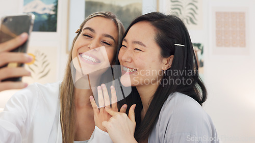 Image of Friends taking selfie with a phone on the wedding morning preparing for the day together in room. Event, smile and happy bride showing her ring while taking picture with her best friend on smartphone