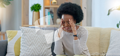 Image of Sad woman crying after reading a breakup text message on her phone. Young female, upset after receiving bad news that has brought her to tears. Suffering from loss or having an emotional breakdown