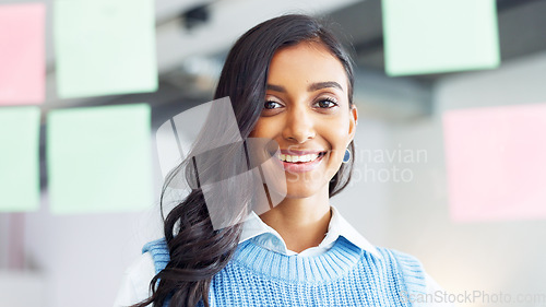 Image of Portrait of a proud female intern looking confident of her brainstorm research idea on a digital tablet while working in an office at work. The face of one happy student searching the web online