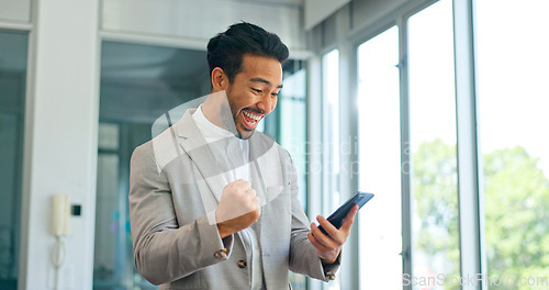 Image of Success, phone and winner with businessman in office and celebration for deal, growth and stock market target. Wow, goals and good news with fist of employee for achievement, future and sale