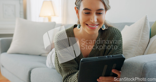Image of Woman, digital tablet and living room app, typing and reading ebook, online shopping and 5g multimedia technology on sofa home lounge. Relax girl on social media, internet website and wifi connection