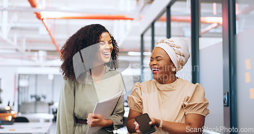 Image of Black women, laughing or walking with business technology, paper or documents in modern office, coworking space or marketing company. Smile, happy or comic creative designers bonding in slow motion