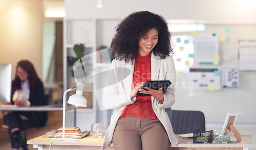 Image of Confident entrepreneur and cheerful HR manager feeling ambitious and motivated for success while planning project ideas online. Happy business woman browsing on a digital tablet in a modern office.