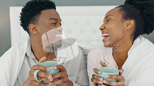 Image of Coffee, smile and a couple drinking in bed together on a lazy day at home. Love, a winter warm up and a hot beverage on a cold morning, black woman and happy man with duvet and a fresh cup in bedroom
