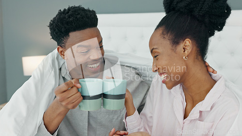 Image of Smile, love and happy black couple drink a cup of coffee on a bed in the morning at home. People in loving, smiling in the bedroom with a warm beverage. Romantic young man and woman bonding in house