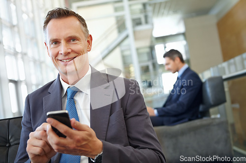 Image of Portrait, happy or business man with phone in office for motivation, company research or website review. Manager or CEO with smartphone in hotel lobby for social network, internet or mobile app