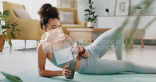 Image of Fitness, relax and woman drinking water in living room with tablet streaming online class for workout, health and exercise. Yoga, internet or e learning with athlete in home gym training for wellness