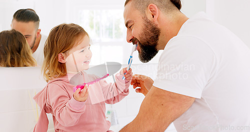 Image of Dental health, father and girl for brushing teeth, together or laugh in bathroom in home to have fun. Oral hygiene, dad and daughter with tooth brush, being happy or bonding for happiness or in house