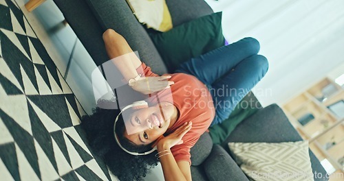 Image of Headphones, listening and dance of black woman on a sofa excited for subscription service, technology and home connection. Happy, relax and girl portrait dancing on couch while listening to music app