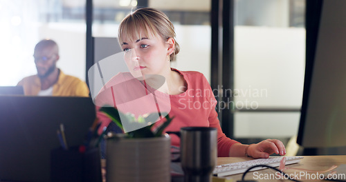 Image of Creative woman, laptop and computer in marketing, advertising or web design multi tasking at the office. Female employee designer in market research comparing data on technology for company startup