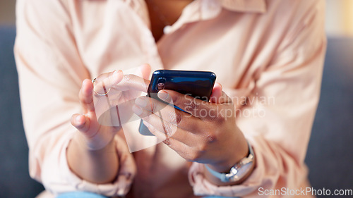 Image of Closeup of hands texting on phone, typing social media post and searching or scrolling online. Relaxed woman sitting alone on home living room sofa and networking and browsing internet on technology