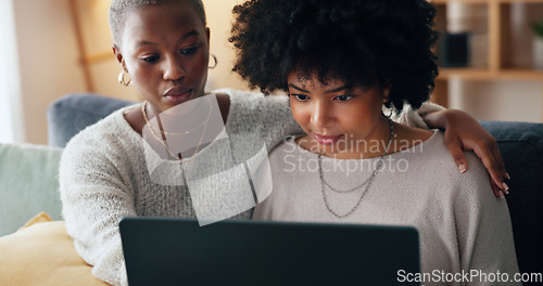 Image of Friends online shopping on a laptop for discount or sale on a digital fintech website at home. Ecommerce, happy and excited African women on the sofa banking on the internet