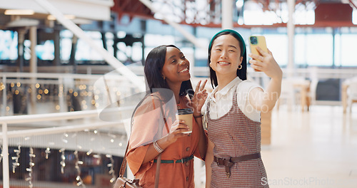 Image of Phone selfie, women and friends with peace sign at mall taking pictures for social media. Bokeh, hand gesture and girls taking photo on mobile smartphone for profile picture or happy memory together.