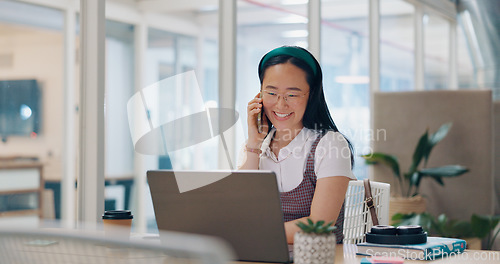 Image of Phone call, communication and business woman writing notes in office. Laptop, cellphone and Asian woman at desk on mobile smartphone chatting, speaking or business deal conversation with contact.