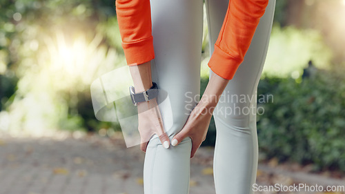 Image of Knee injury, pain or massaging woman or runner rubbing her leg during exercise or workout outside. Wellness, health and physical therapy during cardio training with a female athlete at the park.