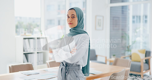 Image of Muslim executive, woman and face with arms crossed in office for vision, success and goal in web design startup. Islamic business leader, mission and focus with goals, dream and innovation in Dubai