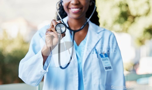 Image of Woman, stethoscope and cardiology doctor for healthcare, life insurance and medical care for wellness. Hand of medicine professional or expert for heart health, healing or hospital consultation check