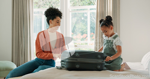 Image of Travel, luggage and mom packing with child in bedroom getting ready for trip. Helping hands, black family and young girl help mother pack clothes in suitcase for holiday, vacation and weekend away