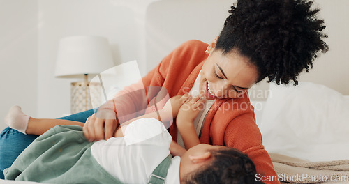 Image of Mother, child and love in home bedroom lying in bed together for fun, tickling and laughing on happy vacation. Black woman parent playing with child for wellness, quality time and holiday memory